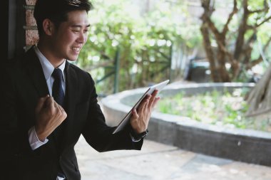 Başarılı iş adamı kontrol mesaj tablet ve yumruk zekâ yükseltmek