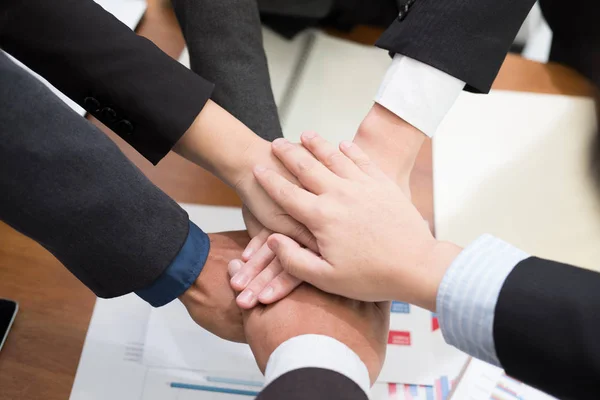 businessman joining hand, business team touching hands together
