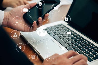 İşadamı akıllı telefondan finansal haritayı analiz eder. Adam onunla çalışıyor.