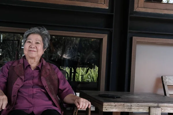 Mujer mayor descansando en la terraza. anciana mujer relajante en patio — Foto de Stock