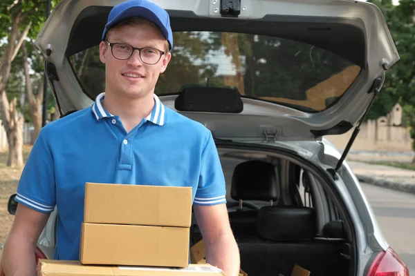 araba arkası, packgage taşıyan teslimatçı. erkek posta couri