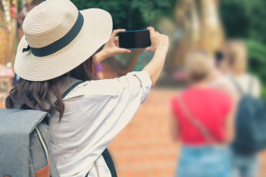 Kadın fotoğraf çekmek için akıllı telefon kullanıyor. Gezgin turist seyahati 