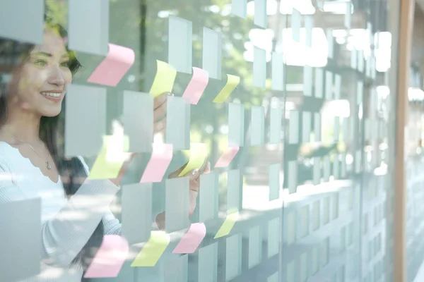 Businesswoman woman thinking planning with adhesive notes on gla — Stock Photo, Image