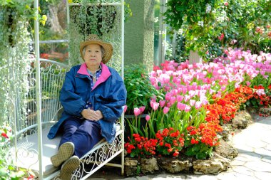 yaşlı yaşlı kadın bahçede dinleniyor. yaşlı kadın rahatlatıcı outdo