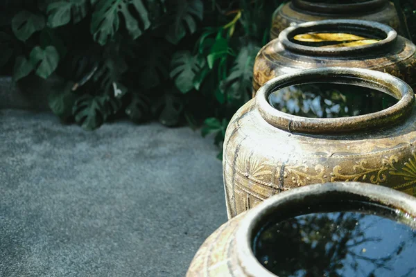 earthen water jar in garden. rain pot reservoir