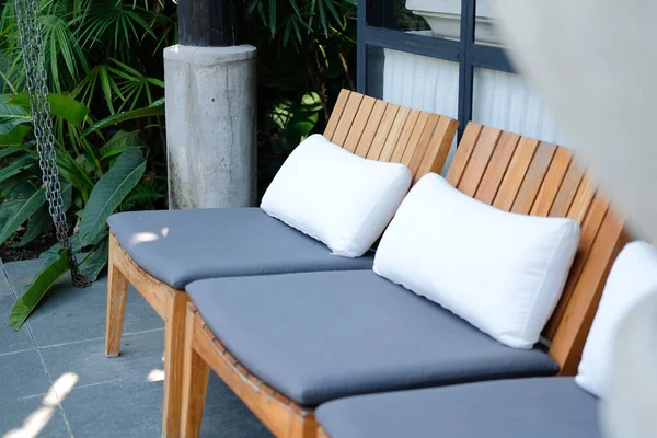 Almofada de travesseiro na cadeira de madeira no hotel resort para relaxar outd — Fotografia de Stock