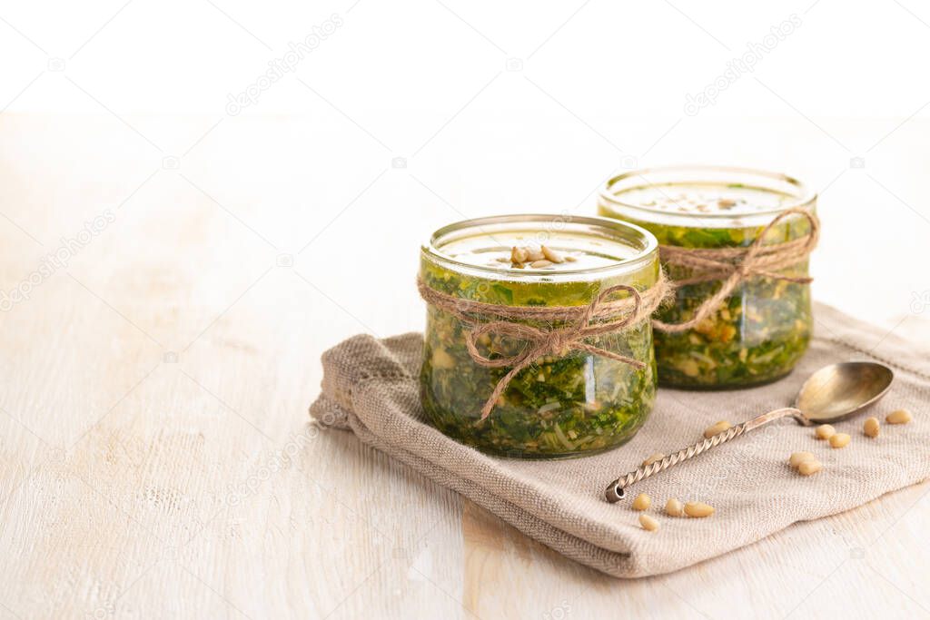 Green pesto sauce. Classic Italian Greens Sauce. Preservation in a glass jar. Close up. 