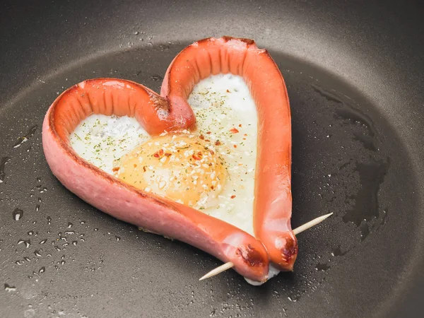 A recipe for a romantic breakfast for Valentine's Day. How to cook heart shaped sausages with fried scrambled eggs. Romantic menu for lovers. Step by step instructions. Set photo 02 of 3