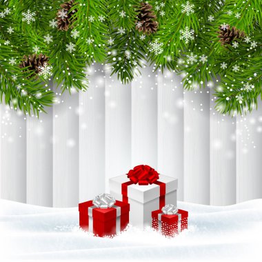 Tahtanın önündeki karda üç hediye kutusu ve yeşil ladin dalları. Noel tatili geçmişi.