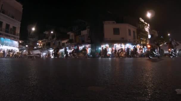 Hanoi, Vietnam - 10th October 2019: The roads and streets of Vietnam in the evening as tourists look at the shops — Stock Video