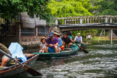 Tam Coc, Vietnam, 16 Ekim 2019: Asyalı turistler güneşli bir günde Ninh Binh 'in kireç taşı mağaralarında kürek turuna çıktılar