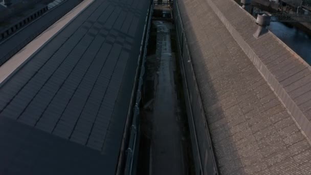 Aerial tilt reveal of Sheffield City over industrial warehouse saw tooth roofs next to the River Don. December, Winter 2019 — Stock Video