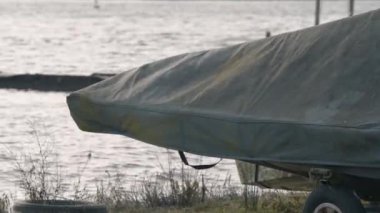 Rowing boat under cover during the winter months in very windy weather, Hornsea, UK