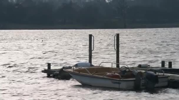 Hornsea, UK - 26th January 2020: Rowing boats tied up to a dock during the cold winter months in Hornsea, East Yorkshire, UK — Stok video