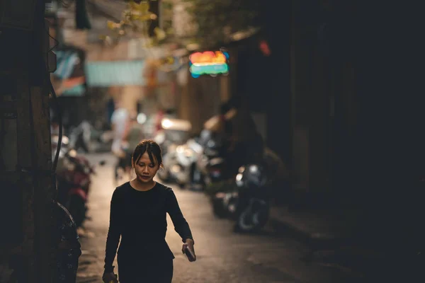 Hanoi, Vietnam: 18th October 2019: A lone Asian female walks towards to camera in a side street with room for text to the right — Stock Photo, Image