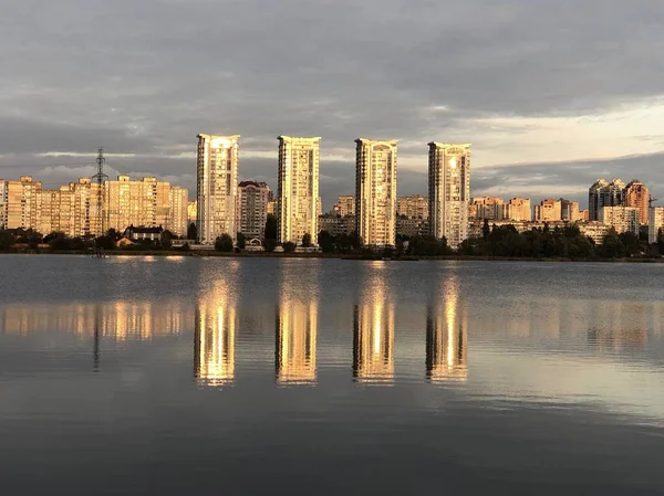 Reflection of tall houses in the lake.