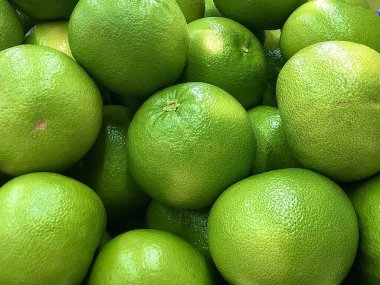 Arka plan dokusu: narenciye, yeşil greyfurt ve sarı portakal. Market rafında egzotik meyveler. Kavram: sağlıklı beslenme, meyve diyeti, vitaminler.