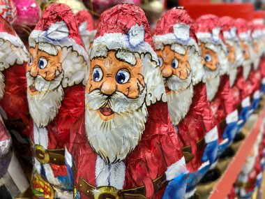 Chocolates in the form of Santa Claus. Christmas sweets on a supermarket shelf. Santa's toy.