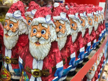 Chocolates in the form of Santa Claus. Christmas sweets on a supermarket shelf. Santa's toy.