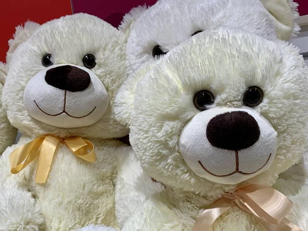 Soft toys on a store shelf. New Year\'s dolls for children in a supermarket. Cartoon characters, polar bear toy.