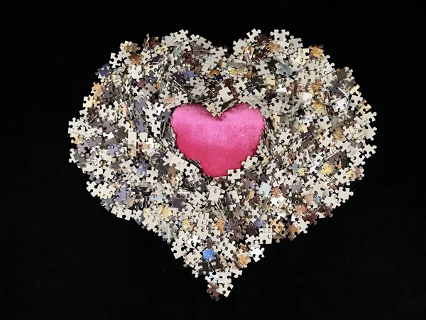 Achtergrondtextuur: hartvorm op achtergrond puzzelpapier. Puzzel in de details in de vorm van een mozaïek. Concept: liefde, relaties, eenheid, hartelijkheid. — Stockfoto