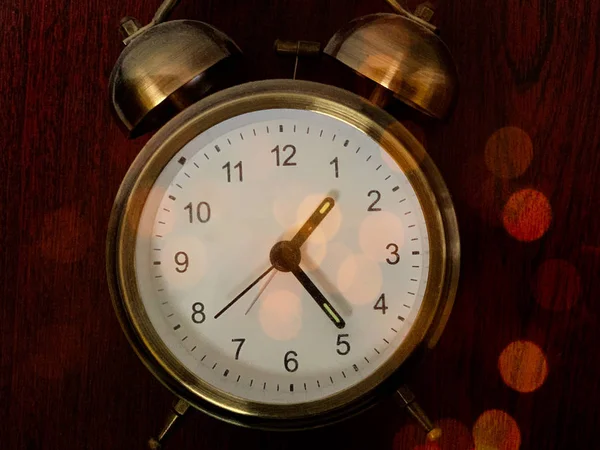 Vintage alarm clock on a dark background. Round clock in multi-colored lights. Desktop mechanical clock with numbers. Concept: Mystery of Time — Stock Photo, Image