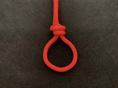 Siyah arka planda parlak bir ip. İp bir düğümle bağlanmış..