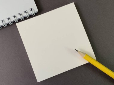 Background texture: school stationery on the desk, yellow and orange. Stationery for the office, free space for writing. Concept: back to school, scissors and paper.