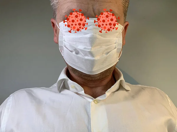 Man in a medical mask, closeup. The male face is covered with a protective medical mask. Concept: coronavirus epidemic, spread of pneumonia, pandemic, Covid-19