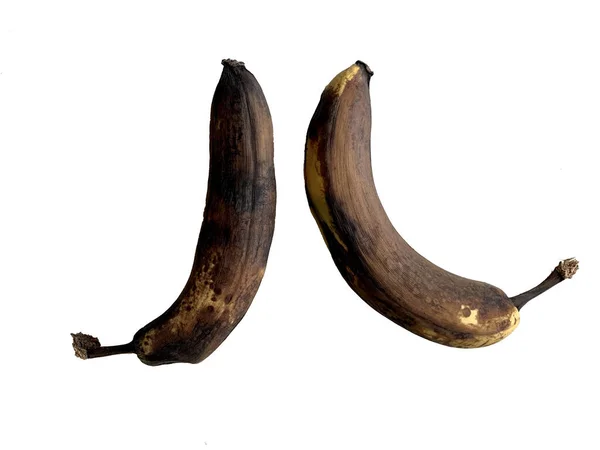 Испорченные Потемневшие Бананы Белом Фоне Старые Несвежие Фрукты Светлом Столе — стоковое фото