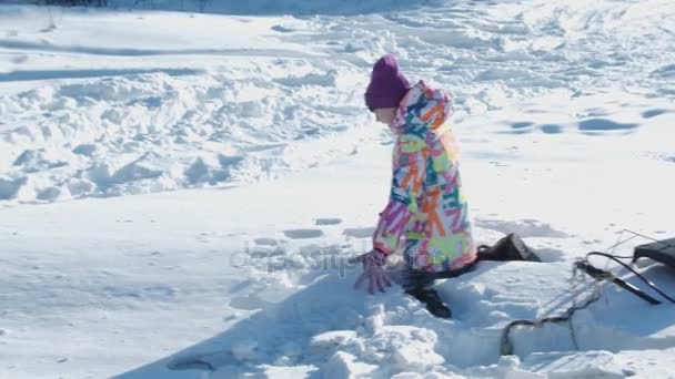 Teen girl sled in winter park, play in snowballs, slow motion, 4K, UHD, UltraHD — Stock Video