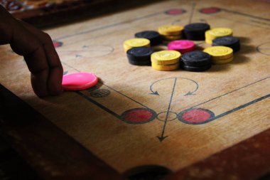 Tahtadaki carromlu parçalarla bir carrom oyunu. Carom masa oyunu, seçici odaklanma..