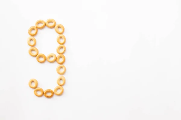 Number 9 made from cookies on a white background with space for text. layout for school or diet — Stock Photo, Image