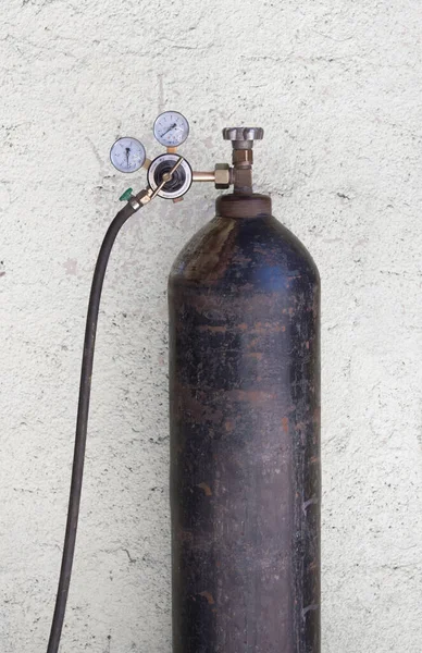 oxygen cylinder with liquefied oxygen, pressure sensors and a hose on a white background. Vintage oxygen cylinder.