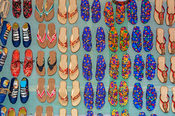 Rows of traditional colorful flip flop and slipper sandals are displayed for selling in a handicraft fair shop at Kolkata.