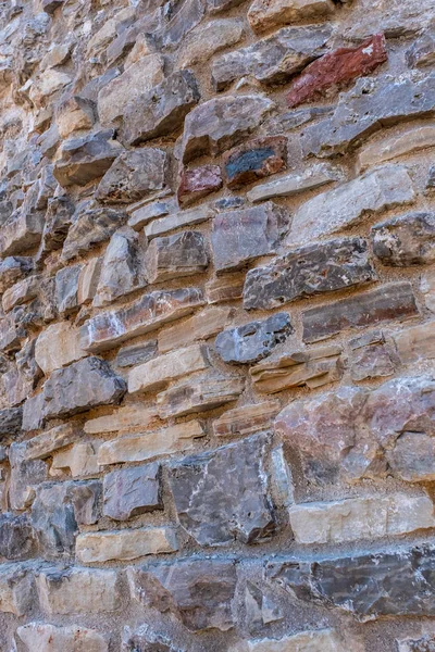 Vieja perspectiva de muro de piedra. primer plano de una antigua muralla medieval — Foto de Stock