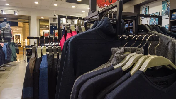 Clothes racks in glasses fashion shop at shopping department store on black friday.