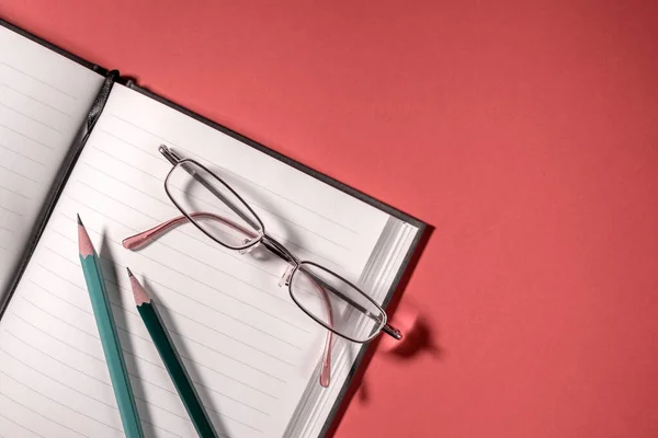 Blank Notepad Red Table Surface Glasses Pencils Business Concept — Stock Photo, Image