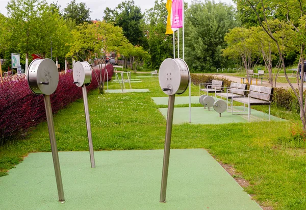 Outdoor gym. Gymnastics in the city park. Sport is health. Gymnastic intervals. Healthy lifestyle. Municipal greenery. Playground. Aerobic exercise. Fitness in the bosom of nature. Table tennis.