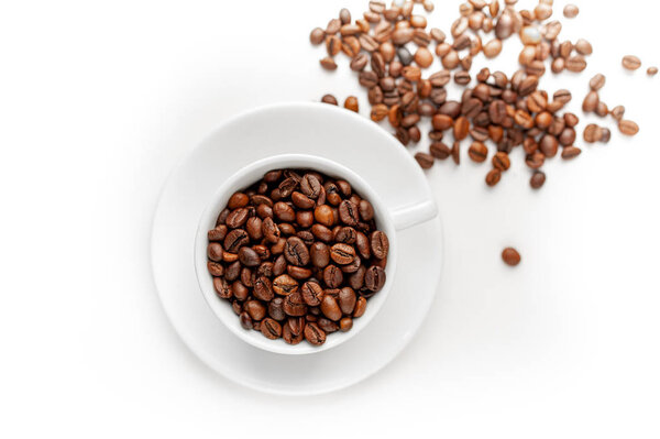 White cup with plate filled with coffee beans