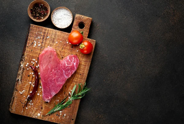 板の上にスパイスや野菜と生のハート型の肉 バレンタインデーのコンセプト — ストック写真