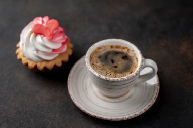 coffee and cake with drawings in the form of a heart on a stone background for Valentine's Day 