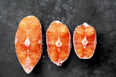 fresh raw salmon steaks on a stone