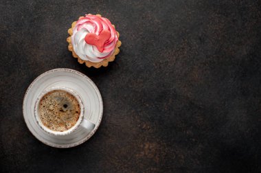 coffee and cake with drawings in the form of a heart on a stone background for Valentine's Day 