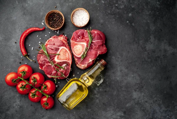 Two Raw Beef Steaks Tomatoes Spices Concrete Background — ストック写真