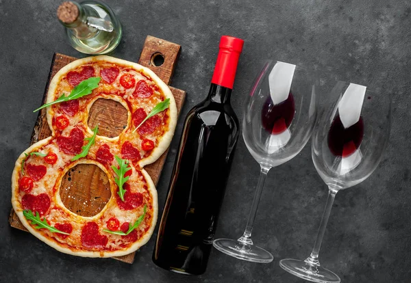 Pizza in form of 8, bottle of wine and glasses for International Women\'s Day on March 8 on a stone background