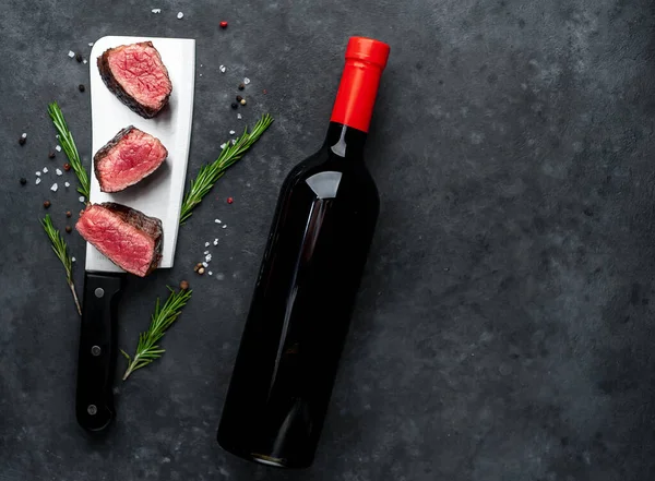 delicious steak and wine on a stone background