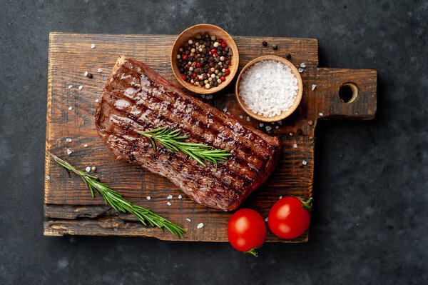 Grilled beef steak on a stone background