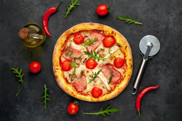 meat pizza with cheese, chicken, ham, mushrooms, tomatoes on a stone background