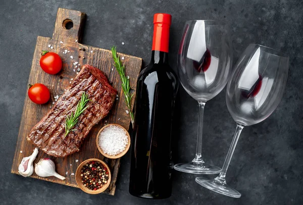 delicious steak and wine on a stone background